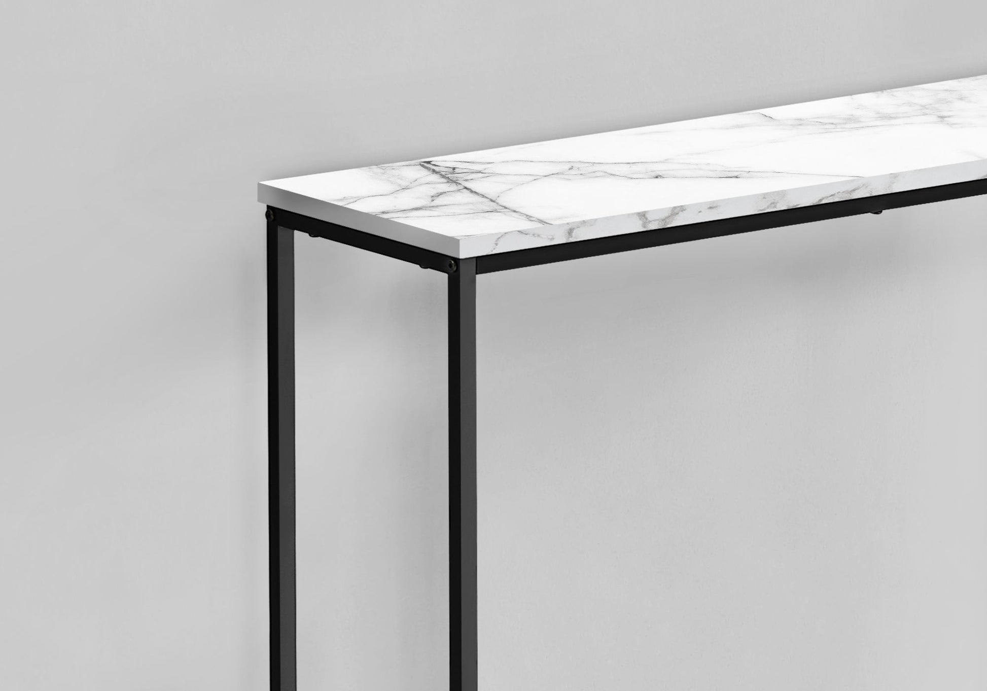 The Accent Console Table For Entryway features a white marble top and slim black metal legs, offering stable support and a contemporary touch against a light gray wall.