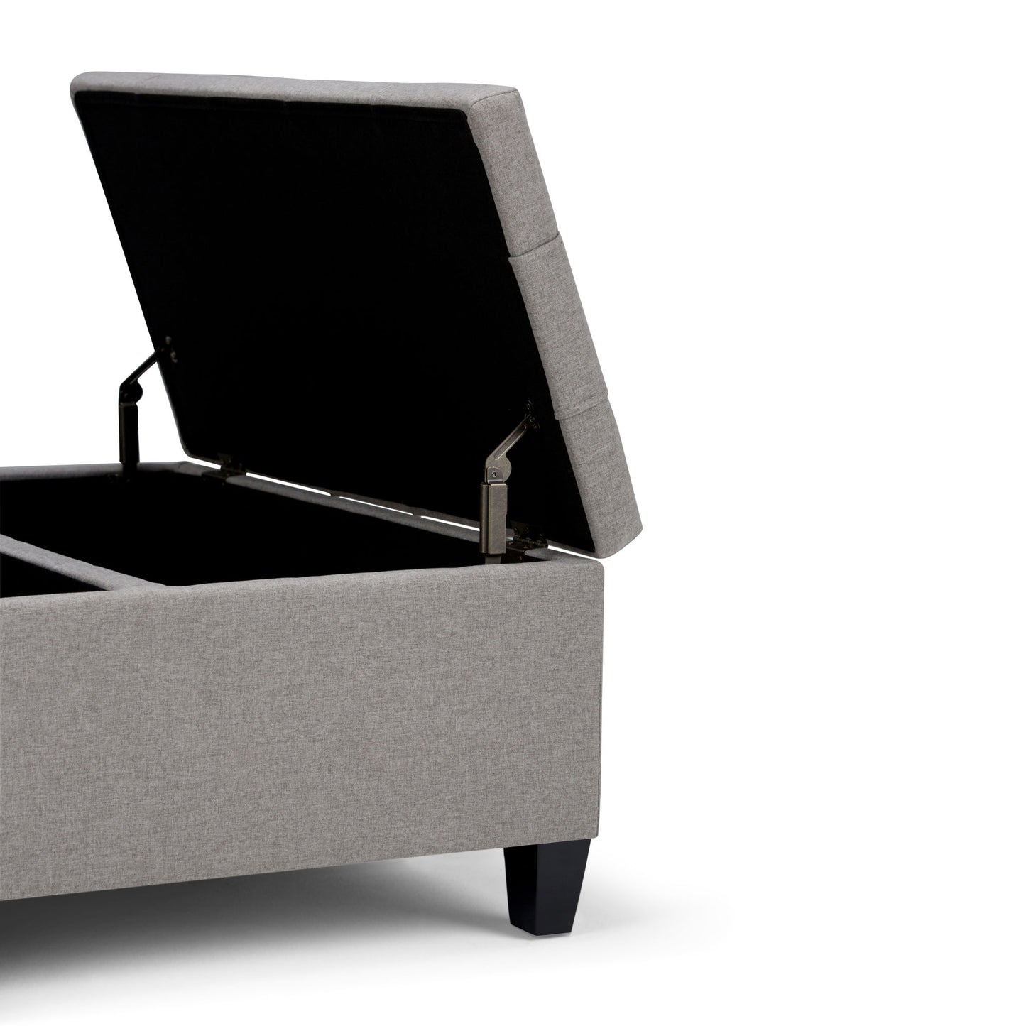 The Harrison Upholstered Coffee Table Storage Ottoman, shown in gray with a hinged lid open to reveal interior storage, features short black legs and is set against a white background.