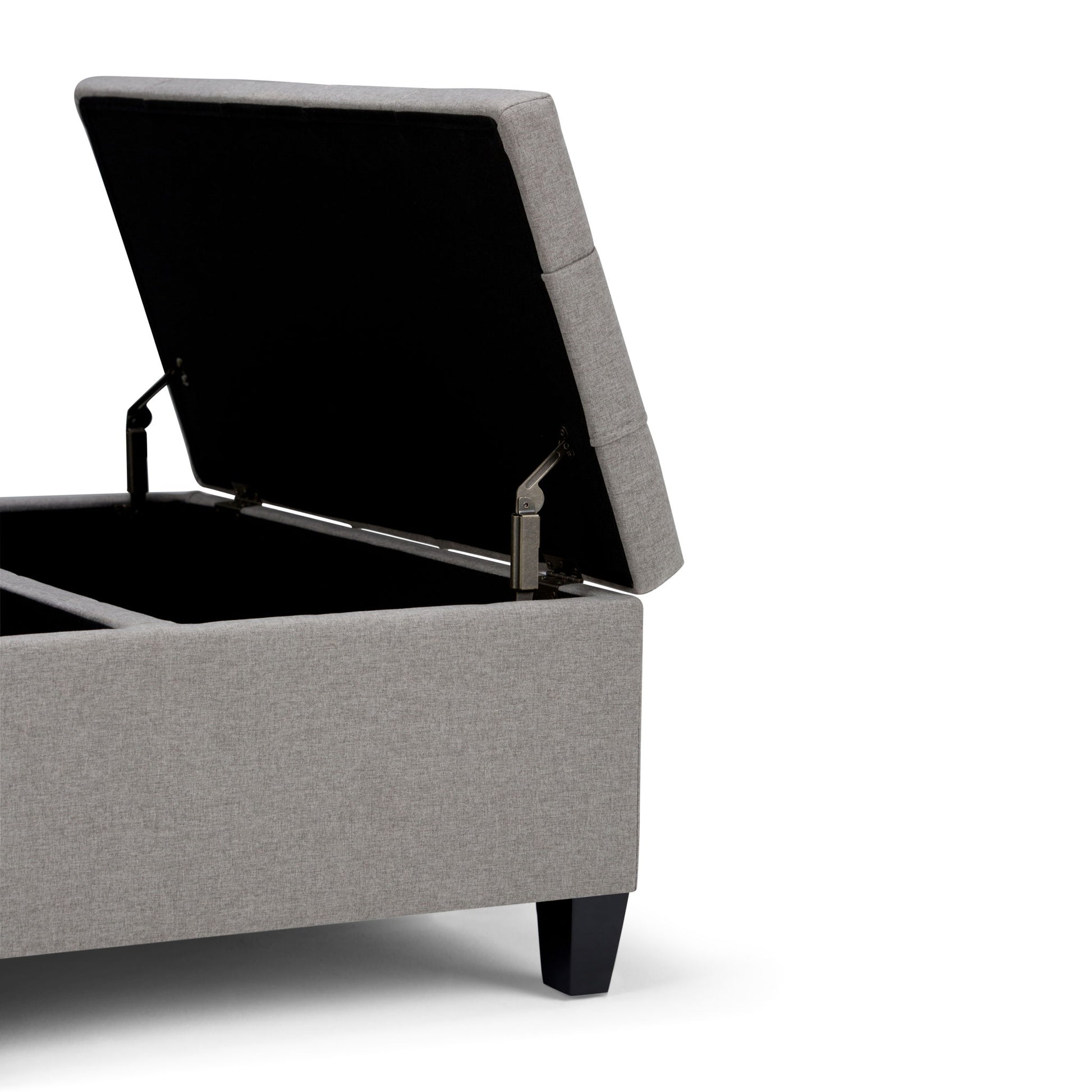 The Harrison Upholstered Coffee Table Storage Ottoman, shown in gray with a hinged lid open to reveal interior storage, features short black legs and is set against a white background.