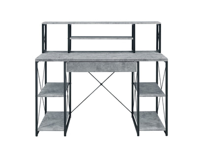 The Amiel All Purpose Writing Desk features a gray concrete-style finish, central drawer, multiple side shelves, open shelving above the surface, and a sturdy black metal frame.