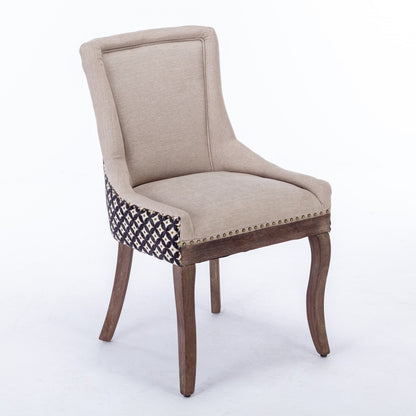 The Ultra Side Dining Chair set features thickened beige fabric, a curved back, neutrally toned solid wood legs, bronze nailhead trim, and patterned detail on the sides—all set against a plain white background.