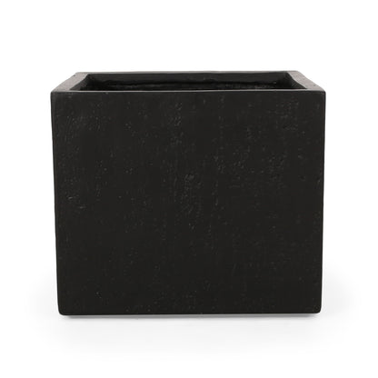 The Modern Outdoor Planter is black, square-shaped with a rough texture and open top, shown against a plain white background.