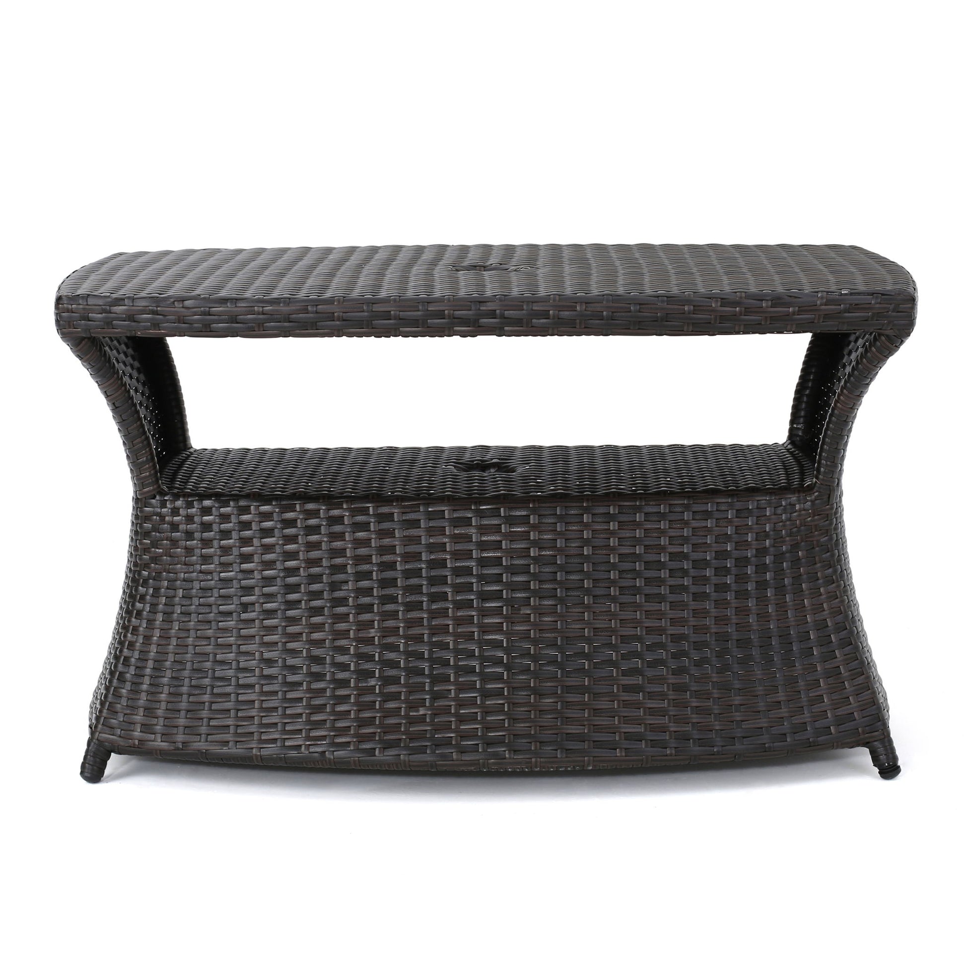 The Berkeley - Chaise Lounge Side Table features a dark brown wicker design with a flat top, open middle shelf, and slightly curved base, ideal for storage or use as a stylish outdoor side table.