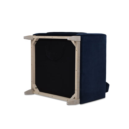 A Knox - Modern Farmhouse Arm Chair is shown upside down, revealing its wooden frame and black fabric underside. The fabric cover looks smooth and the chair features a rectangular shape.
