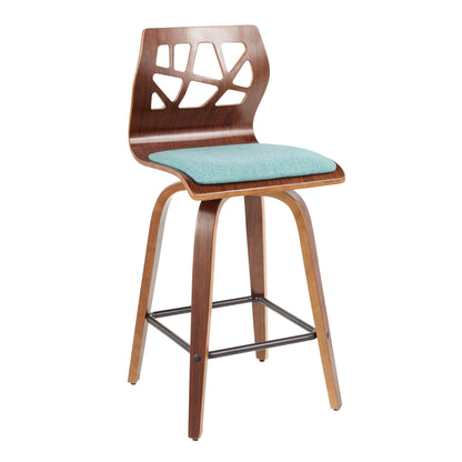 The Folia Mid Century Modern Fixed Height Counter Stool (Set of 2) features curved wooden seats and backrests with geometric cutouts, light blue cushions, four angled legs, a metal footrest, and swivel functionality.