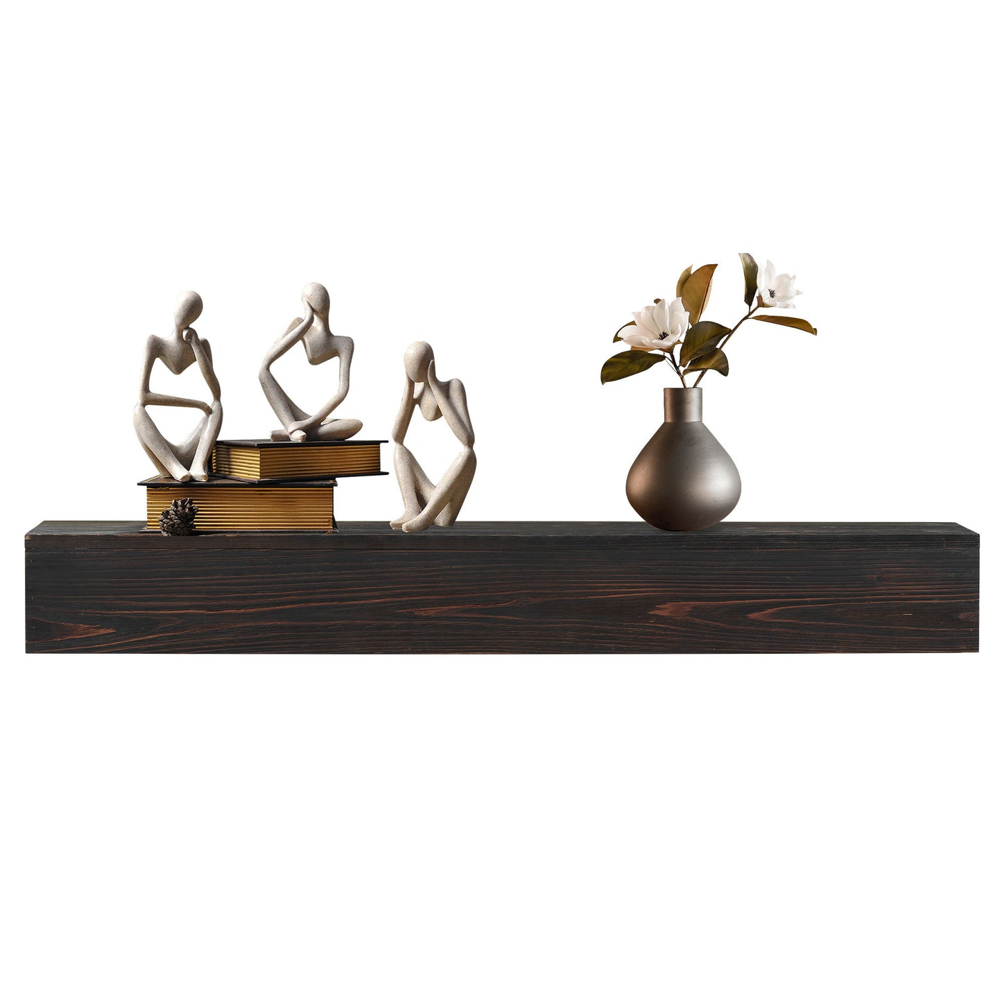 The Rustic Wood Fireplace Mantel, a wall-mounted floating shelf, displays three abstract human figurines, stacked books, a pine cone, and a gray vase with white flowers and green leaves as home decor.