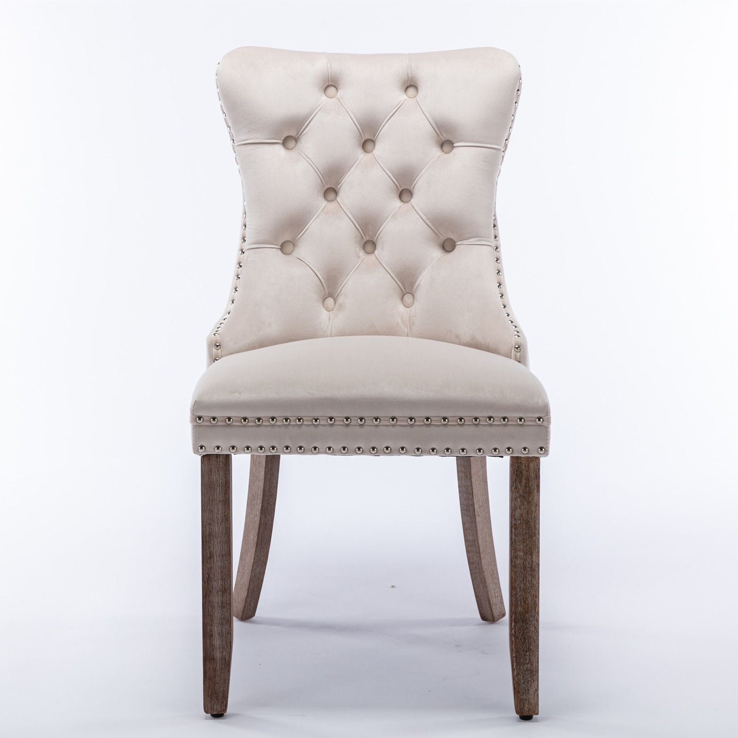 The Nikki set features two modern, high-end dining chairs with tufted velvet upholstery, solid wood legs, and nailhead trim, shown against a plain white background.