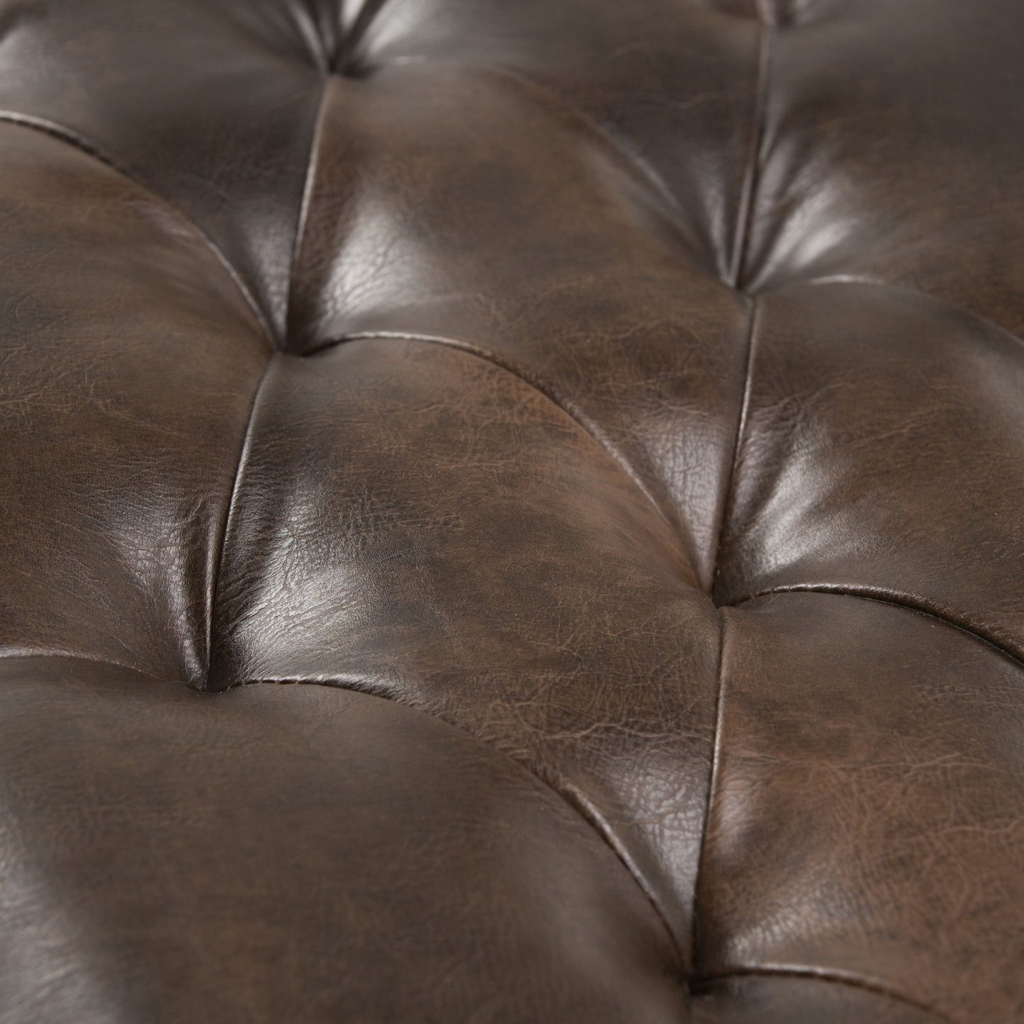 Close-up of the Henley Tufted Ottoman Bench in distressed brown, highlighting button details, natural leather texture, visible creases, and a rich sheen.
