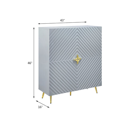 The Gaines High Gloss Accent Cabinet features a modern gray finish, diagonal textured doors, gold star-shaped handles, and gold legs. Dimensions: 43"W x 46"H x 16"D.