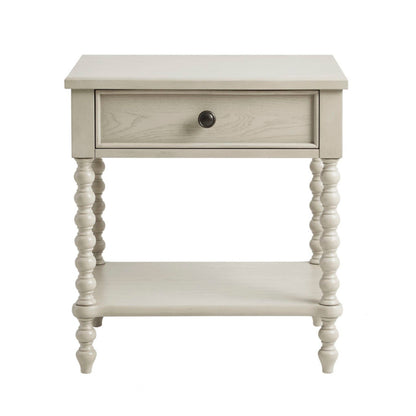 The Traditional Durable Nightstand Table With Drawer And Shelf features a light wood finish, single drawer with round knob, turned legs, and an open lower shelf for simple yet elegant style.