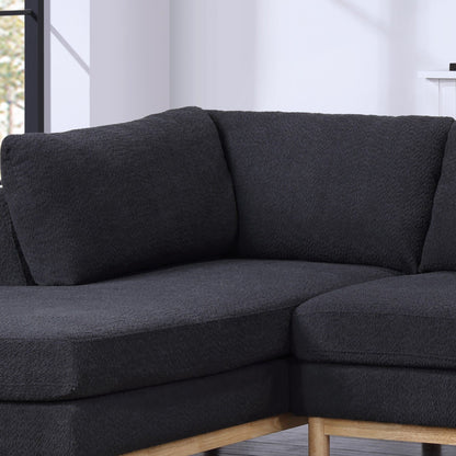 A close-up of the Hallie Wide Sherpa Double Chaise U-Shape Sectional Sofa with wooden legs, shown in a bright room with light walls and a window in the background.
