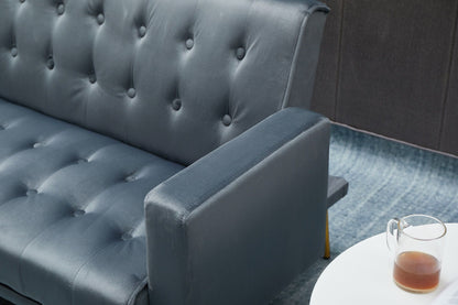 A close-up of the Comfort Compact Design Sofa Bed in dark blue, placed beside a small white round table holding a clear glass mug with tea or coffee on a blue textured carpet.