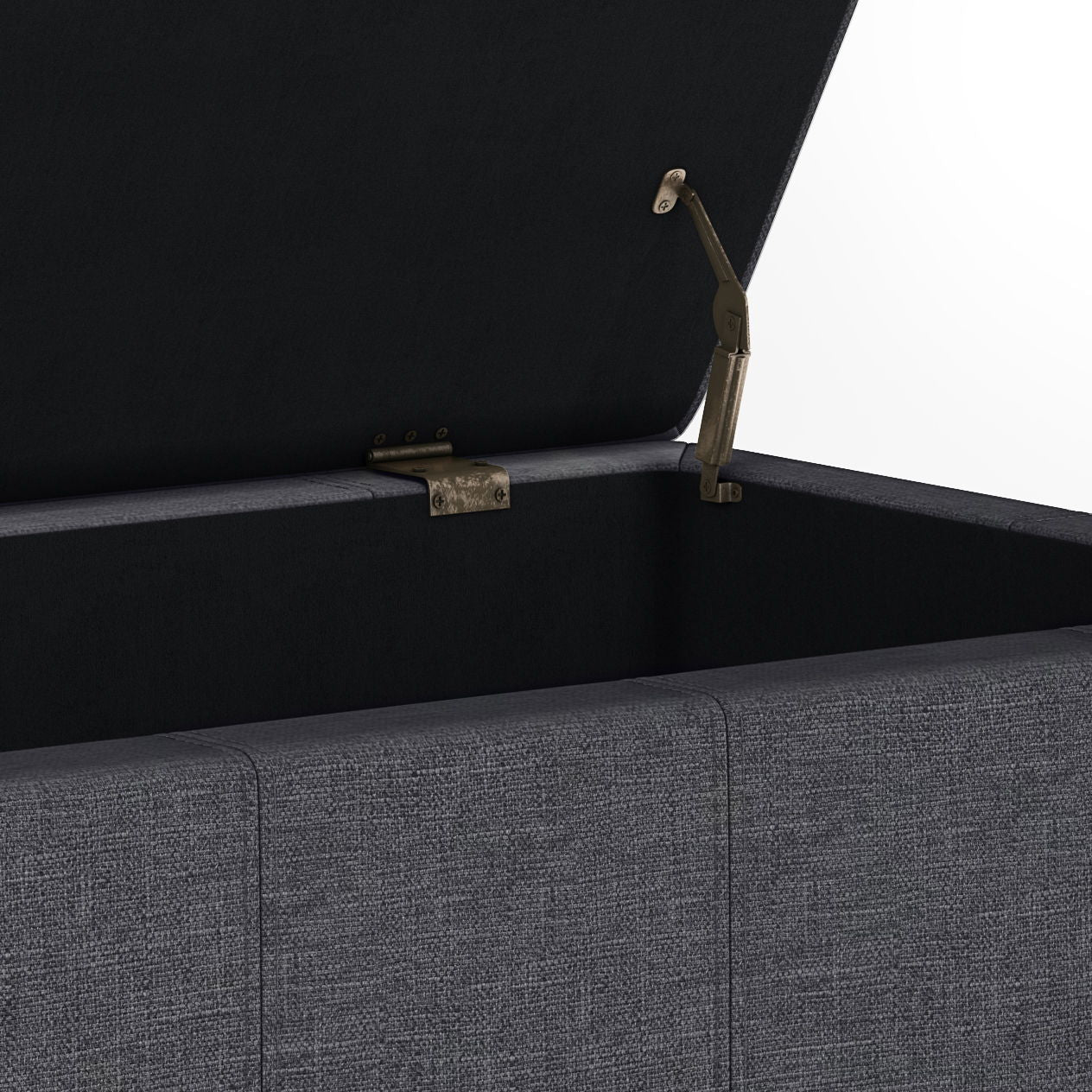 A close-up of the Dover - Upholstered Storage Ottoman Bench, featuring an open gray fabric exterior, hinged lid with metal support, and an empty interior lined with dark fabric.