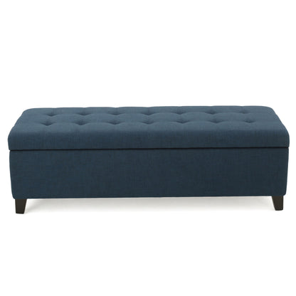 The Nebulous Fabric Upholstered Ottoman With Storage features a navy blue diamond tufted seat and short black legs, shown from the front against a white background.