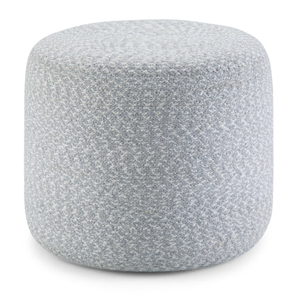 The Bayley - Versatile Round Braided Pouf features a light gray, soft textured fabric and a simple, modern design.