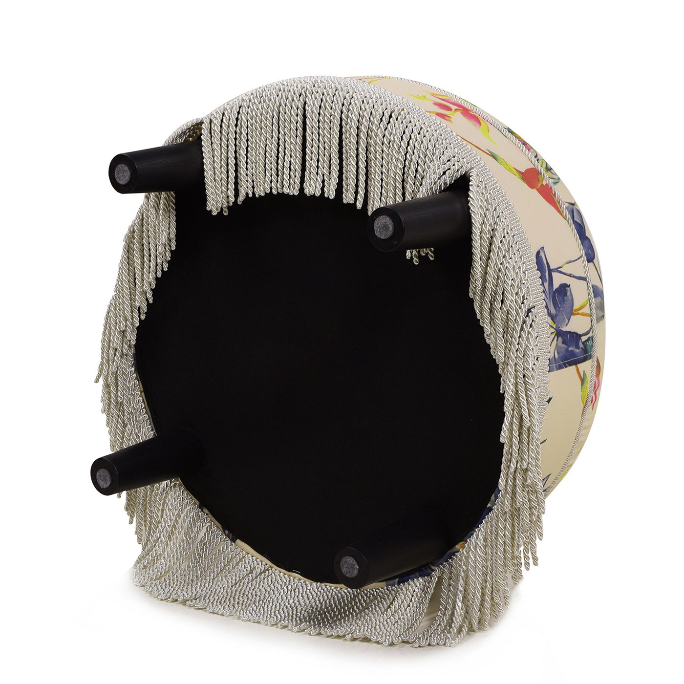The Yolanda Round Upholstered Accent Ottoman features a floral pattern, four black legs, and decorative silver fringe around the edge. It is shown upside down.