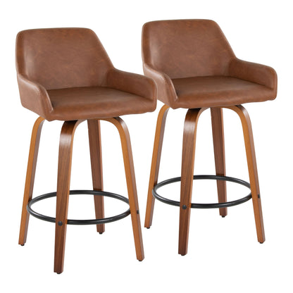 A pair of Daniella Contemporary Fixed Height Counter Stools with swivel, round black metal footrests, curved wooden legs, and brown faux leather low-back seats with armrests are shown side by side on a white background.