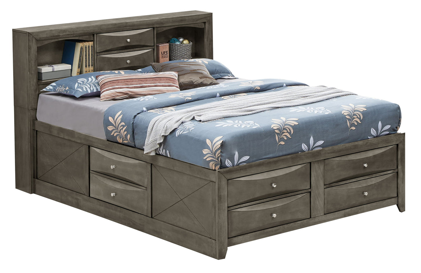 The Marilla Storage Bed With Bookcase Headboard is a grey wooden frame featuring storage drawers on the sides and front, plus a headboard with shelves and small drawers. It's styled with blue, white, and brown bedding and pillows.