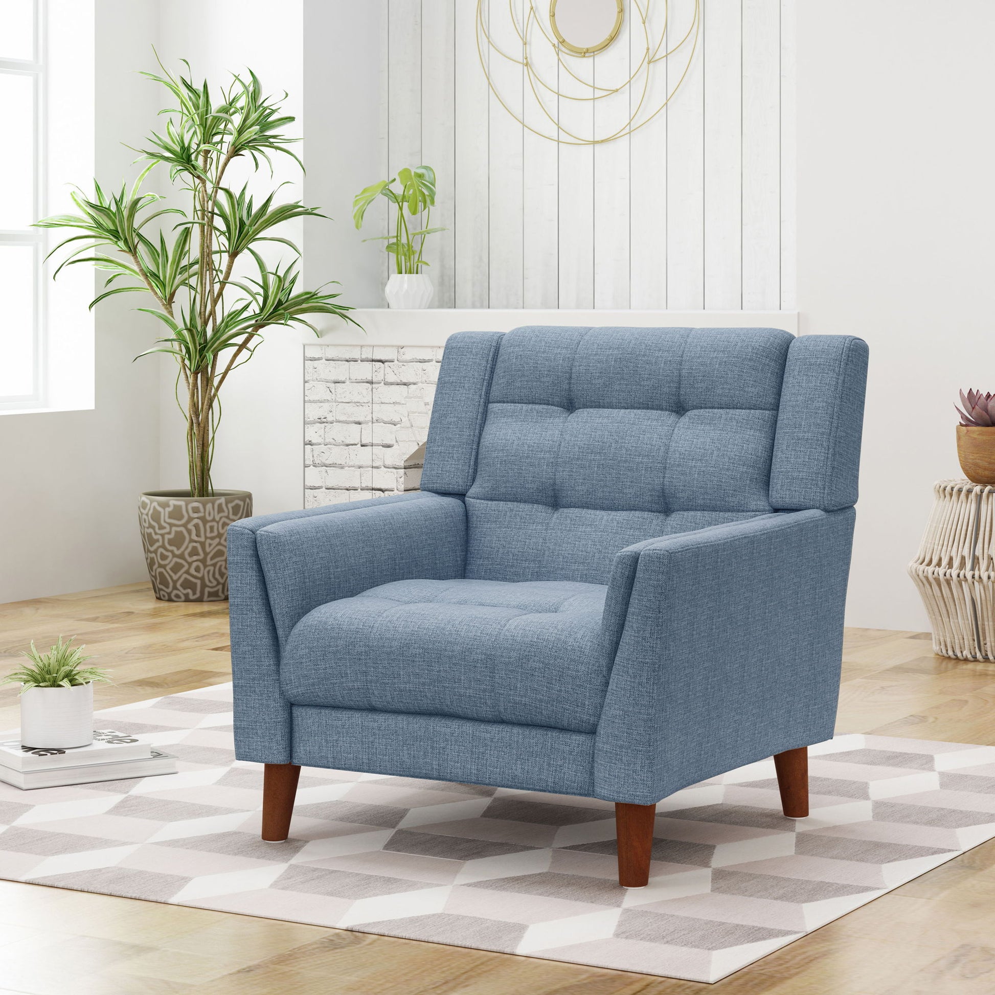 The Luminaesque Fabric Upholstered Armchair with a tufted back and wooden legs stands on a patterned rug in a bright, modern living room featuring plants, a white fireplace, and decorative wall art.