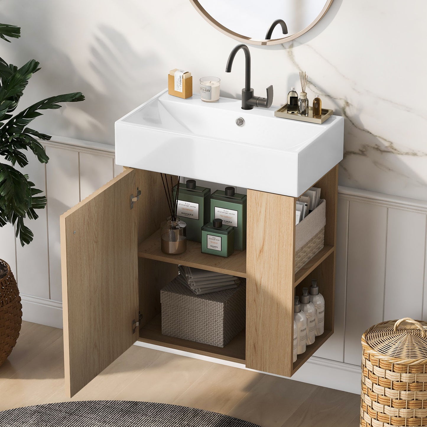 The Modern Floating Bathroom Vanity With Ceramic Basin is perfect for small bathrooms and features a white rectangular sink, black faucet, open wood cabinet with organized storage shelves, plus a round mirror and plant nearby.
