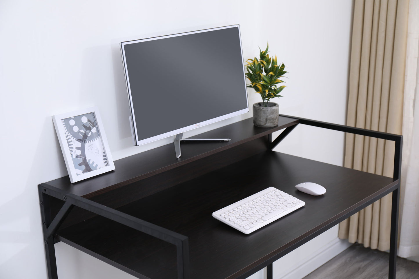 A sleek black Console Table Narrow Modern Entryway Table displays a computer monitor, white keyboard, mouse, potted plant, and framed abstract art against a white wall with beige curtains—perfect for modern living rooms or hallways.