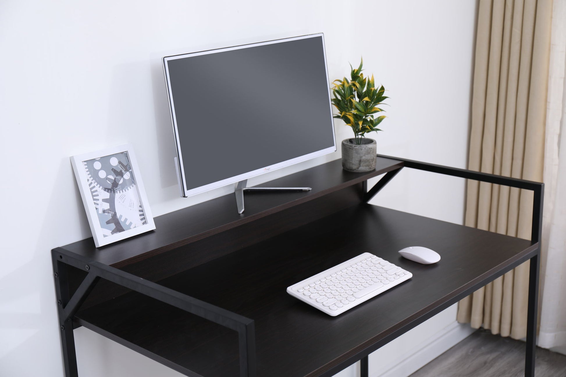 A sleek black Console Table Narrow Modern Entryway Table displays a computer monitor, white keyboard, mouse, potted plant, and framed abstract art against a white wall with beige curtains—perfect for modern living rooms or hallways.