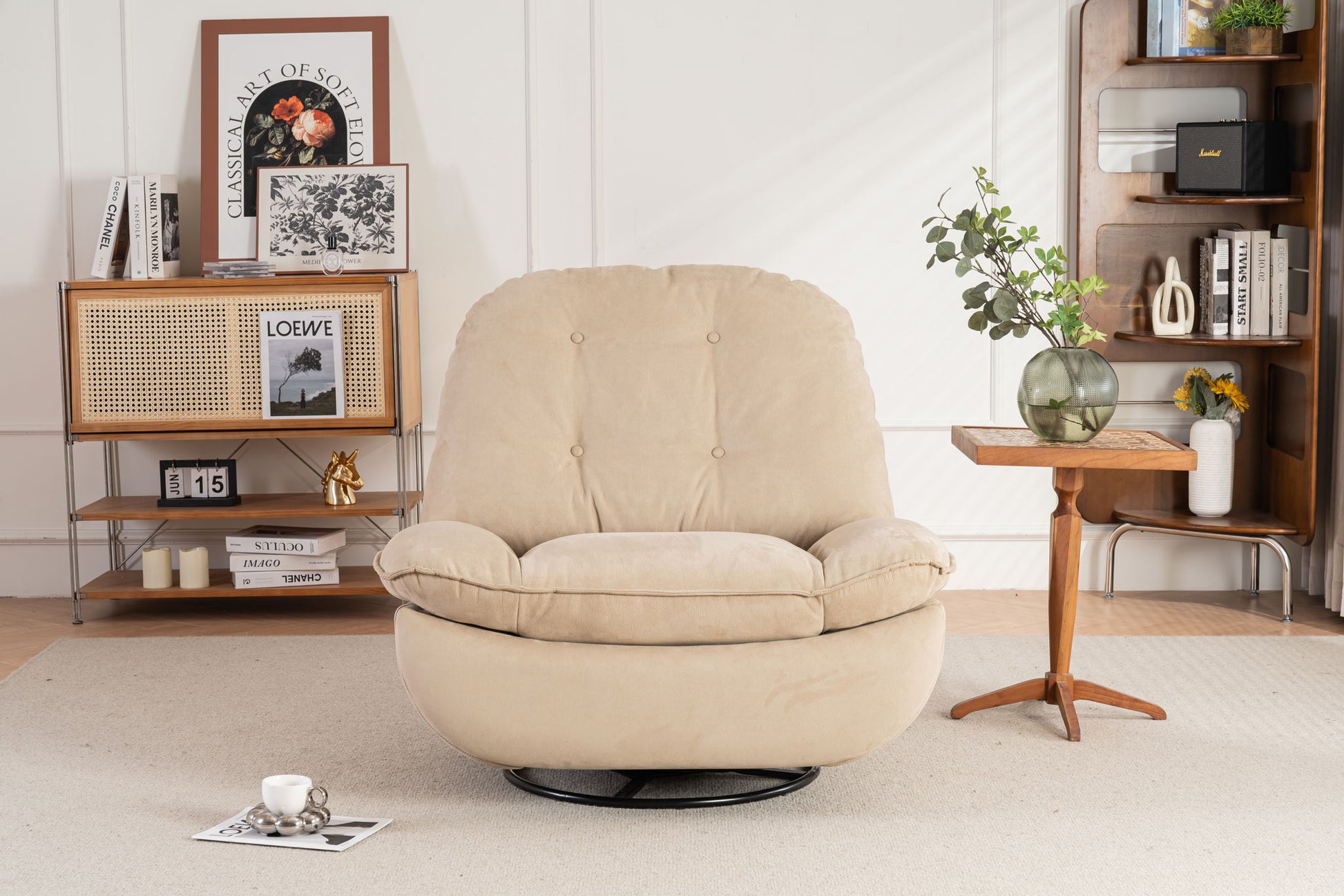 A Power Recliner Swivel Glider with USB charger and Bluetooth music player sits on a light rug in a stylish living room, beside a wooden side table and bookshelves filled with books, magazines, and decorative items.