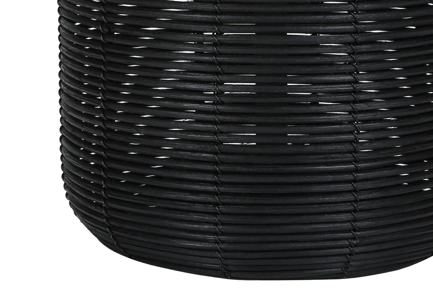 Close-up of a modern table lamp crafted from black rattan, highlighting the detailed interlaced texture and cylindrical shape with gently curved sides.