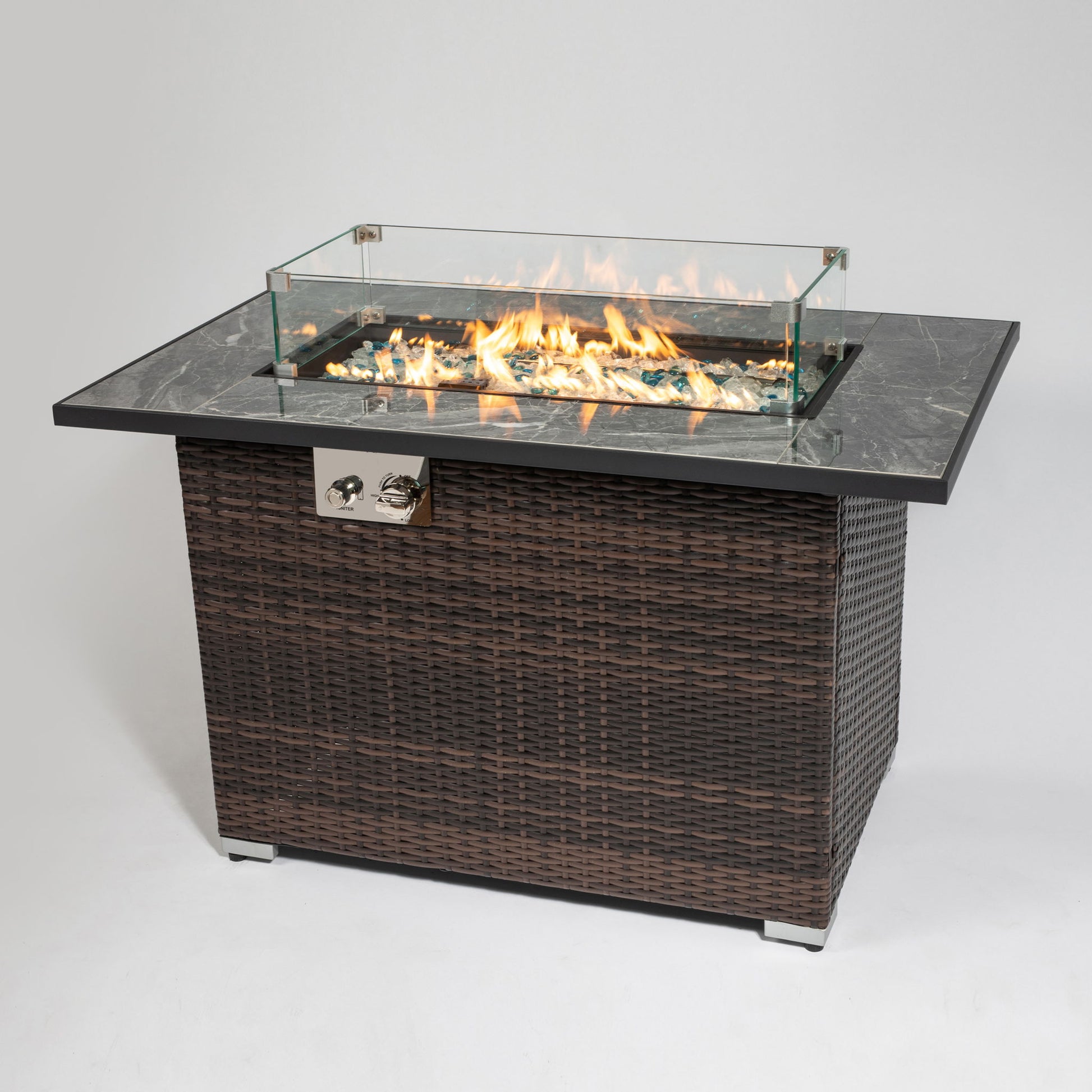 The 44" Outdoor Fire Pit Table features an espresso wicker base, a ceramic tabletop, and a glass wind guard around the flames, shown on a plain white background.