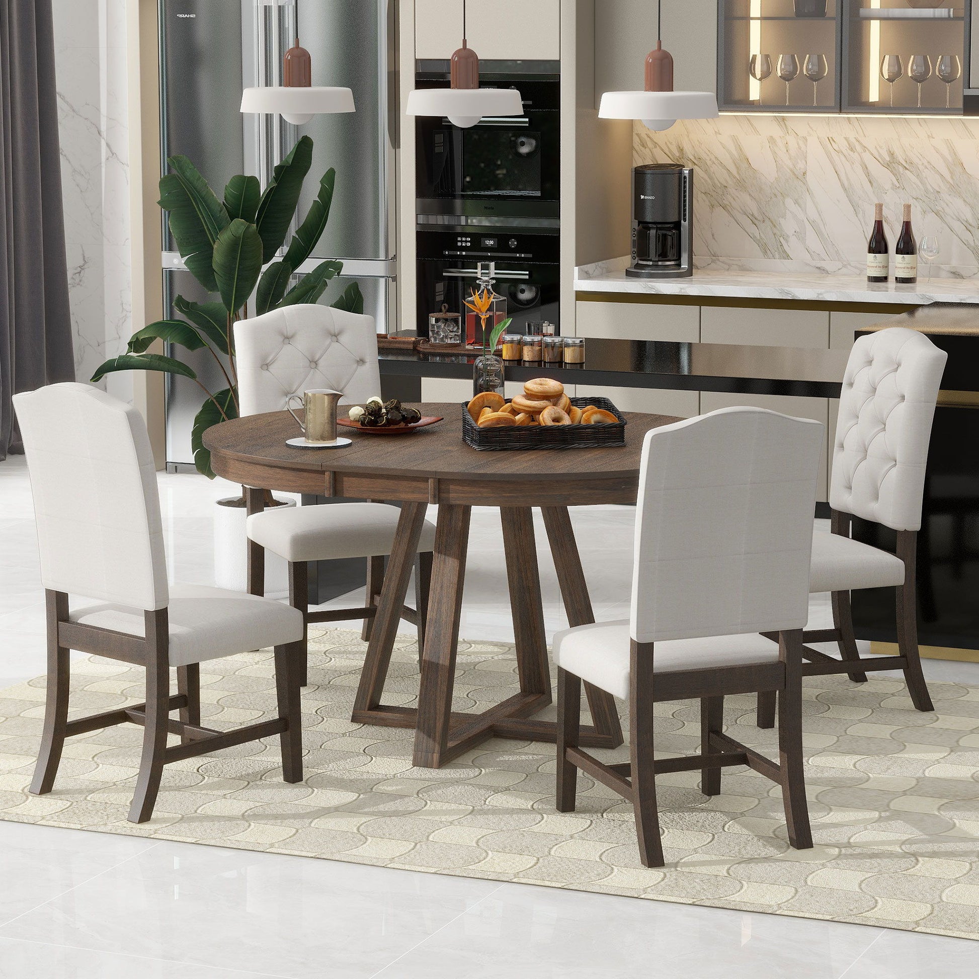 A modern dining room features the Retro Functional Dining Set—a round table with leaf and five upholstered chairs—set for breakfast with pastries, fruit, and coffee. The background showcases a kitchen with a marble backsplash and hanging lights.