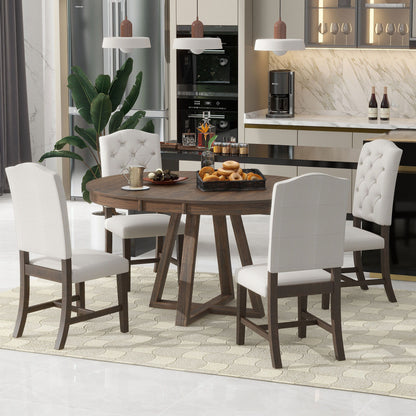 A modern dining room features the Retro Functional Dining Set—a round table with leaf and five upholstered chairs—set for breakfast with pastries, fruit, and coffee. The background showcases a kitchen with a marble backsplash and hanging lights.