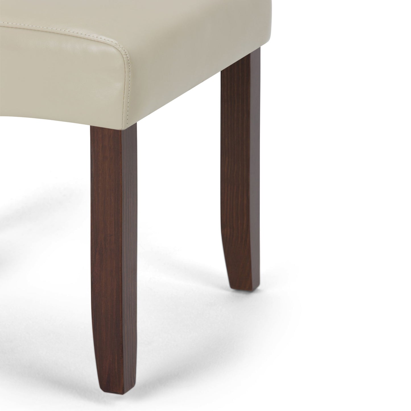 Close-up of the Cosmopolitan - Deluxe Tufted Parson Upholstered Chair (Set of 2), featuring a light beige upholstered seat and two dark brown wooden legs against a white background.