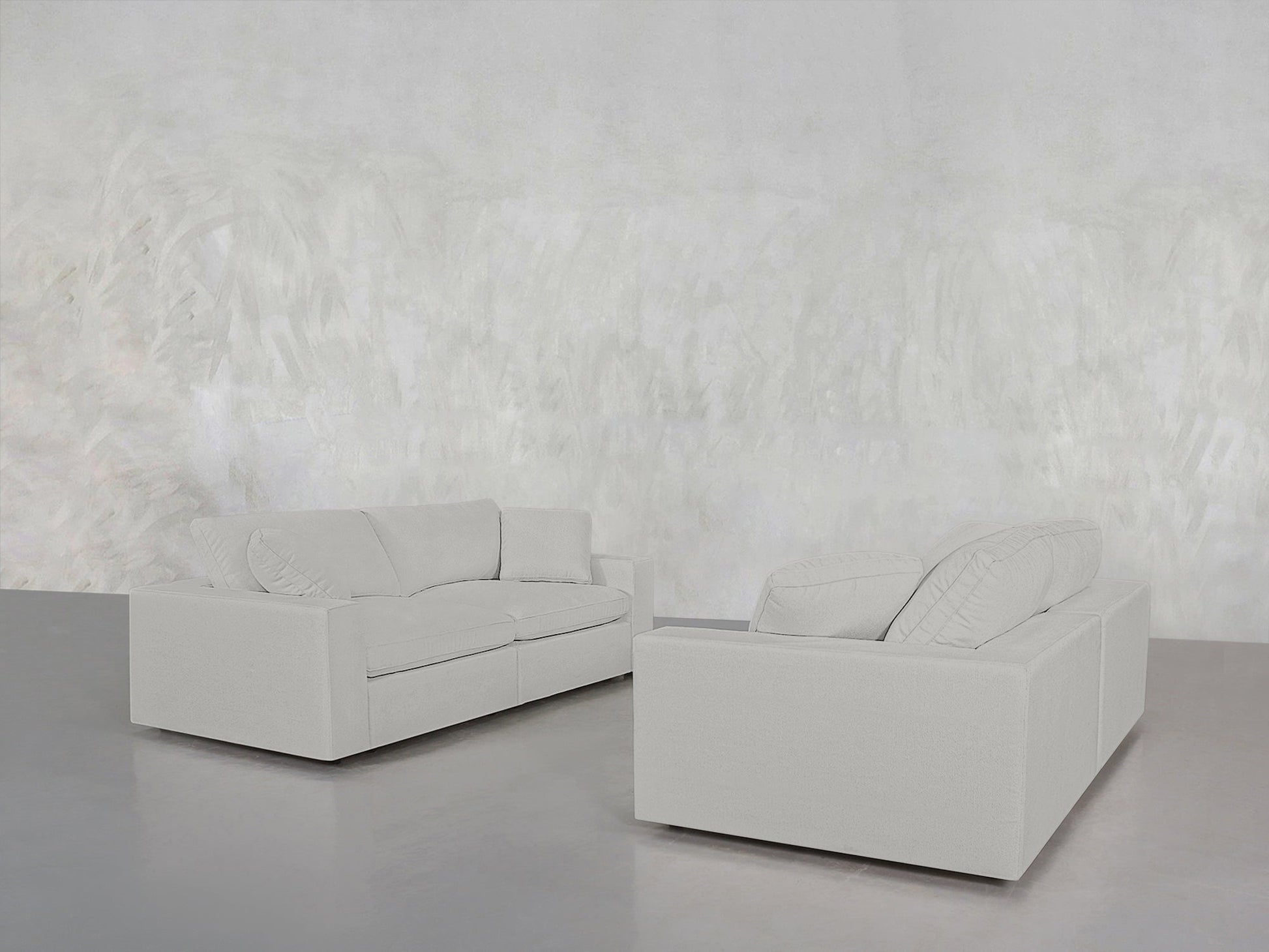 The minimalist room features a 2-2 Sofa Set in light gray, with two modern sofas facing each other against a matching textured wall and glossy gray floor. The space is empty except for the sofa set.