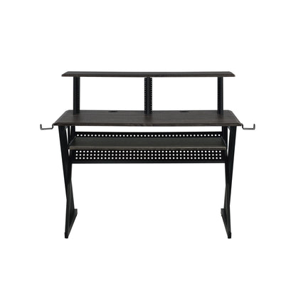 The Humanity - Music Desk - Black features a dark wood surface, raised shelf, metal frame, two side hooks, and perforated paneling underneath—ideal for studio or office use.