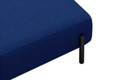 A detailed view of the Palo 3-seater Sofa shows its blue fabric and black cylindrical leg. The fabric's texture stands out, while the design presents a modern and minimalist style against a white backdrop.