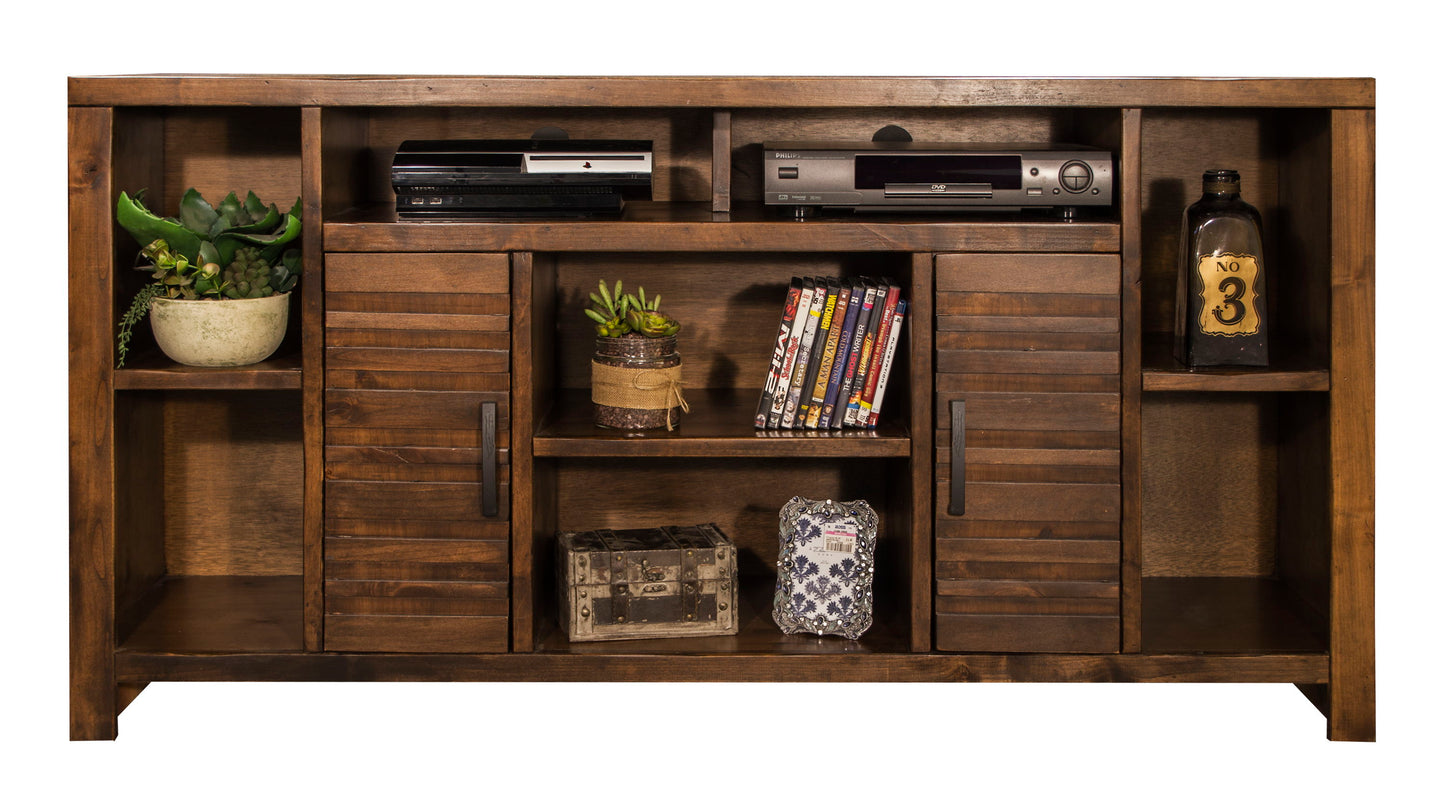 The Sausalito TV Stand Console holds plants, electronics, a vintage bottle, DVDs, and decor on open shelves. Its center features two louvered cabinet doors plus open shelving for extra storage and display.