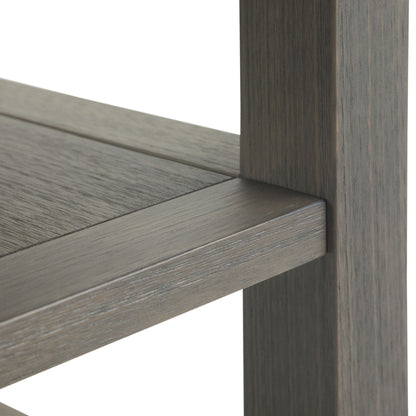 Close-up of the corner joint on the Acadian - Narrow Side Table, Handcrafted, highlighting the smooth texture and grain of its grayish-brown wood. The table looks sturdy and well-crafted.