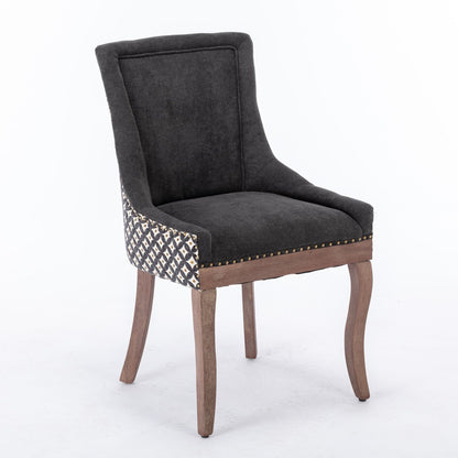 The Ultra Side Dining Chair set features thickened fabric in dark gray, neutrally toned solid wood legs, patterned side panels, and bronze nail head trim along the front edge, shown against a white background.