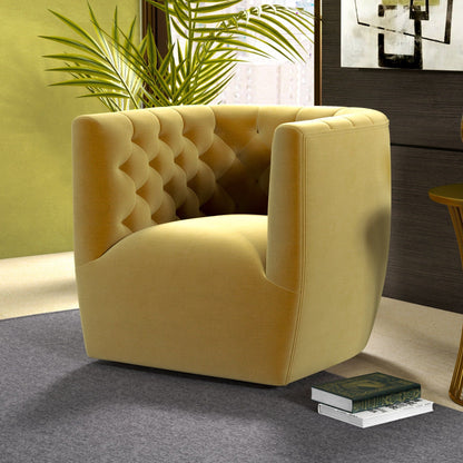 The Delaney Ergonomic Design Swivel Chair in yellow velvet with a tufted backrest sits on a gray rug near a plant and two stacked books, with abstract wall art and a wooden table in the background.