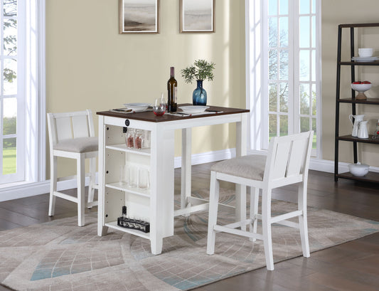 The Graham 3 Piece Small Space Counter Height Dining Table with Shelves and 2 Chairs Set sits on a patterned rug in a bright room. The rectangular table features open shelves with glassware, while large windows fill the space with natural light.