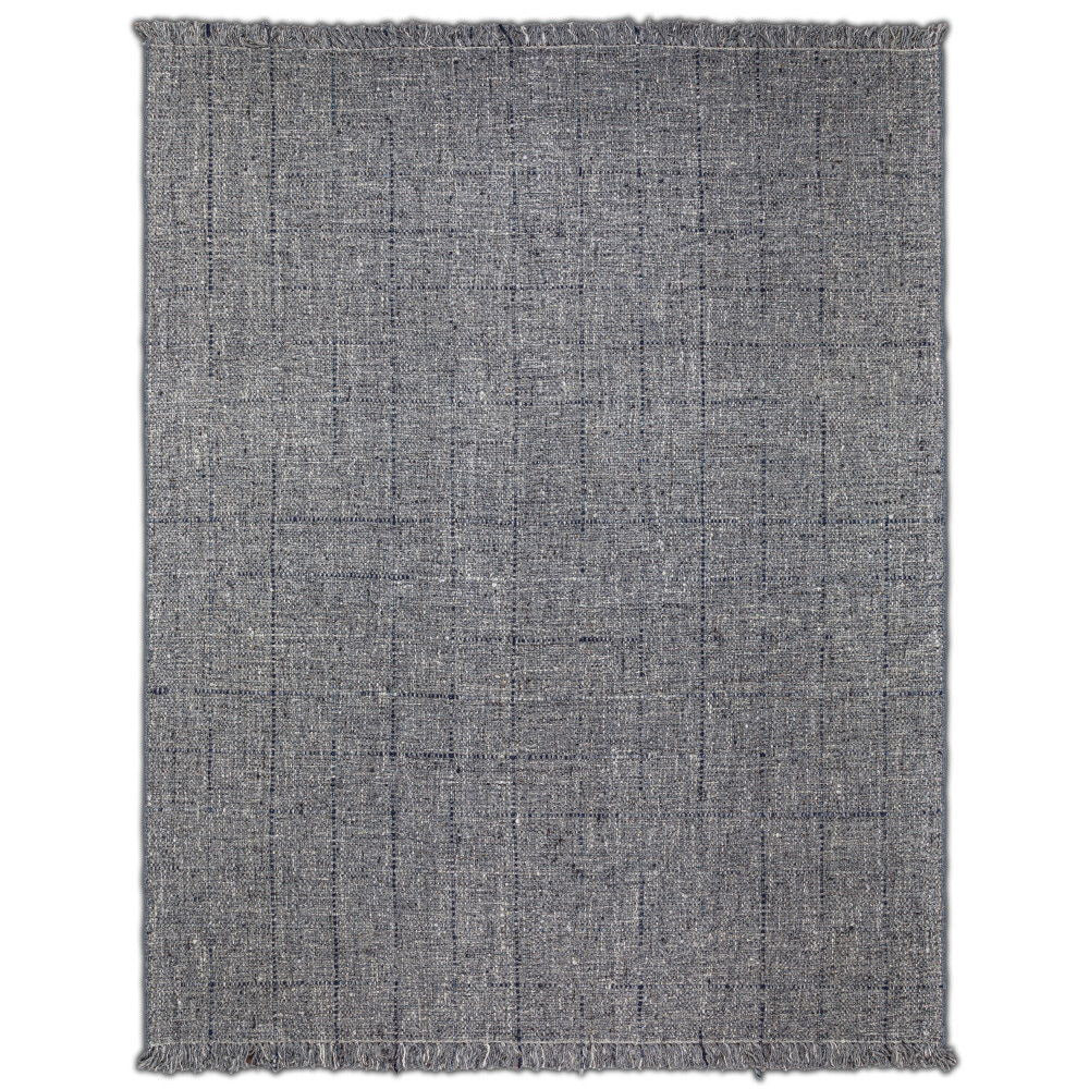 The Tenney Handcrafted Area Rug is a rectangular, gray woven rug featuring subtle linear patterns and fringed edges on all sides, shown flat against a white background.