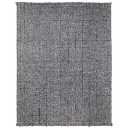 The Tenney Handcrafted Area Rug is a rectangular, gray woven rug featuring subtle linear patterns and fringed edges on all sides, shown flat against a white background.