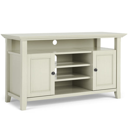 The Amherst - TV Media Stand, Handcrafted, features a light wood finish, two side cabinets, three open center shelves, a top shelf, and a circular cable management hole on the back panel.