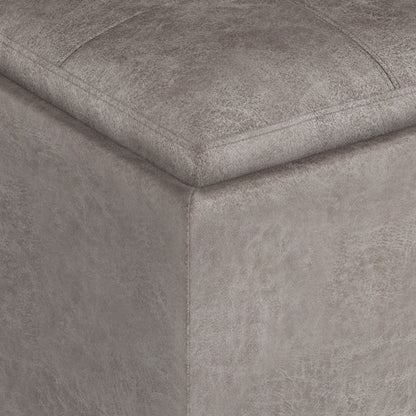 Close-up of the corner of the Rockwood Upholstered Cube Storage Ottoman With Tray, highlighting stitched seams and textured gray fabric.