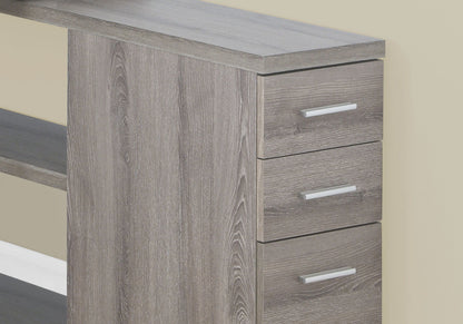 A modern Computer Desk with an L shape and storage drawers is set against a beige wall. It has open shelving on the left and silver-handled drawers on the right, ideal for laptops in contemporary home offices.