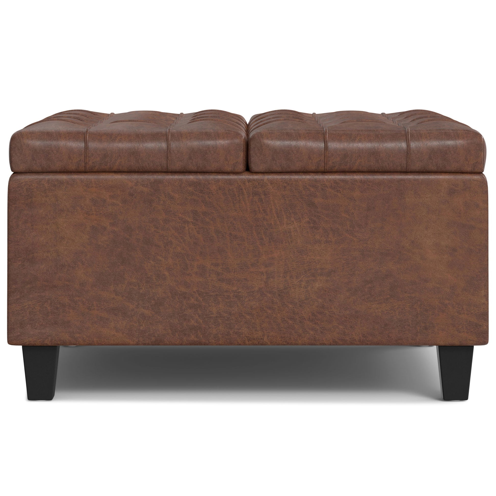 The Harrison - Large Coffee Table Storage Ottoman features brown leather, a tufted cushioned top, black legs, and a rectangular design, shown from the front on a white background.