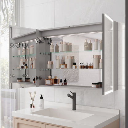 A modern bathroom features a Bathroom Medicine Cabinet With Lights, showcasing neatly arranged skincare and cosmetics on glass shelves above a sink with a soap dispenser and faucet. The LED medicine cabinet includes a mirror and defogger.