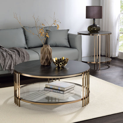Modern living room with a gray sofa, Abisha Sintered Stone Top Round Table holding a geometric vase and decorative bowl, side table with lamp, white rug, and sunlight streaming through the window.