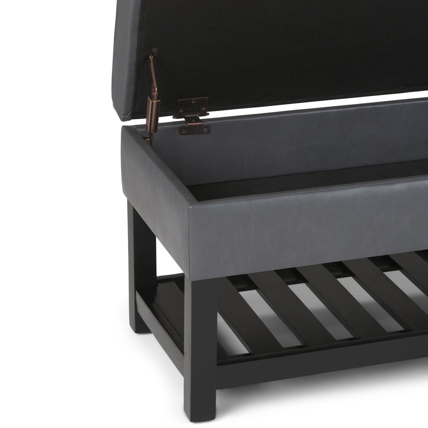 A close-up of the Cosmopolitan Storage Ottoman Bench With Open Bottom shows its black cushioned lid lifted open, revealing an empty storage compartment and a slatted shelf beneath, all supported by a dark wooden frame and legs.