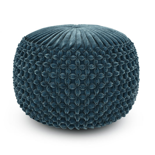 The Renee - Handcrafted Round Pouf is a round, teal ottoman featuring textured, petal-like sides and a pleated top, shown against a white background.